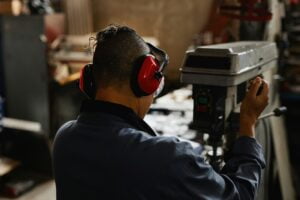 Female Worker Wearing Ear Protection At Factory